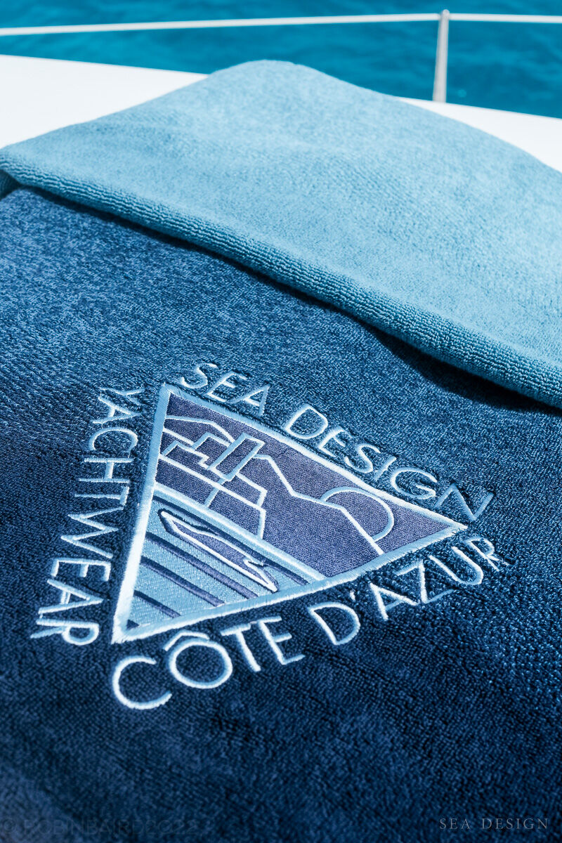The Sea Design logo embroidered on a navy towel